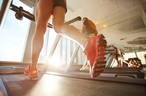 Woman running on a treadmill in a gym